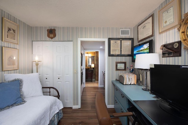 157 Capri D, Delray Beach, FL 33484 - bedroom with wallpapered walls, dark wood-style floors, a closet, and a desk