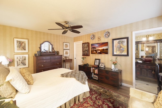 157 Capri D, Delray Beach, FL 33484 - bedroom with wallpapered walls, wood finished floors, and ceiling fan