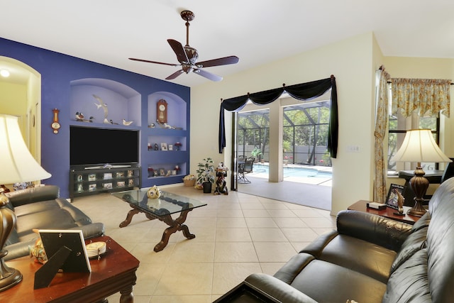 3429 SW Catskill Dr, Port Saint Lucie, FL 34953 - living room with a ceiling fan, tile patterned floors, arched walkways, and built in shelves