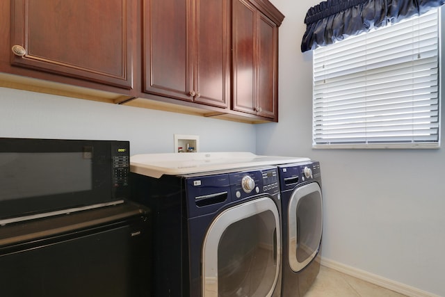 3429 SW Catskill Dr, Port Saint Lucie, FL 34953 - washroom with washer and clothes dryer, cabinet space, and light tile patterned flooring