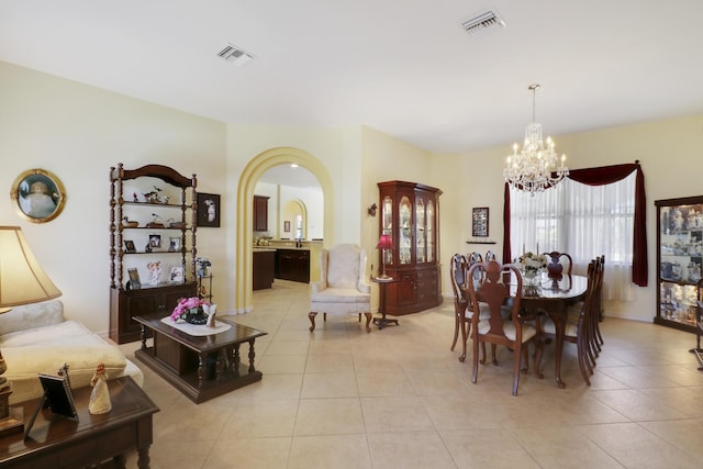 3429 SW Catskill Dr, Port Saint Lucie, FL 34953 - dining space featuring a chandelier, arched walkways, and light tile patterned floors