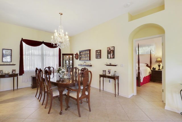 3429 SW Catskill Dr, Port Saint Lucie, FL 34953 - dining room with a chandelier, light tile patterned floors, and arched walkways
