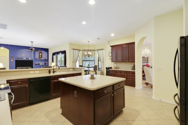 3429 SW Catskill Dr, Port Saint Lucie, FL 34953 - kitchen with dishwasher, a chandelier, freestanding refrigerator, light tile patterned flooring, and light countertops
