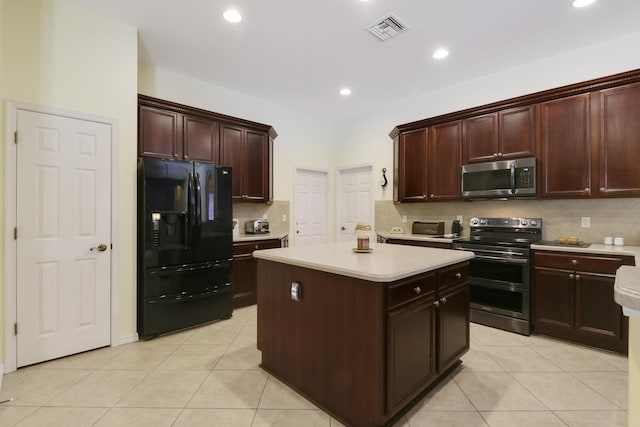 3429 SW Catskill Dr, Port Saint Lucie, FL 34953 - kitchen with appliances with stainless steel finishes, tasteful backsplash, light countertops, light tile patterned floors, and a kitchen island