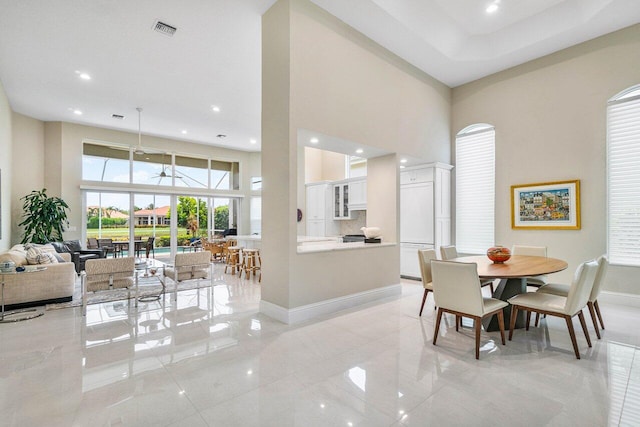 391 Isle Ct, Palm Beach Gardens, FL 33418 - dining space with a towering ceiling, recessed lighting, and light tile patterned flooring