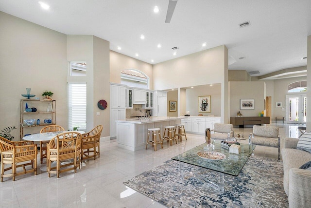 391 Isle Ct, Palm Beach Gardens, FL 33418 - living area featuring a towering ceiling and recessed lighting