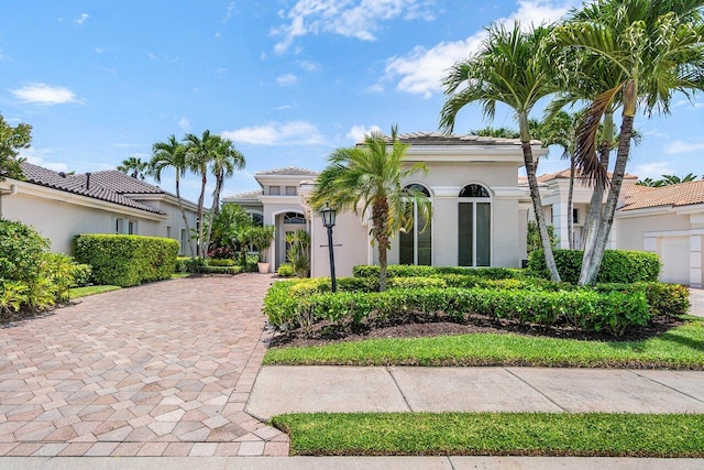 391 Isle Ct, Palm Beach Gardens, FL 33418 - mediterranean / spanish house featuring stucco siding and driveway