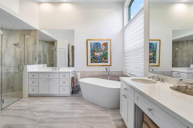 391 Isle Ct, Palm Beach Gardens, FL 33418 - full bath featuring a shower stall, two vanities, marble tiled flooring, a soaking tub, and a high ceiling