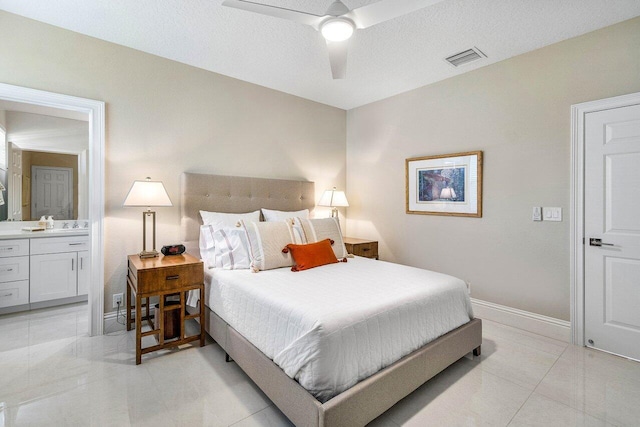391 Isle Ct, Palm Beach Gardens, FL 33418 - bedroom with ensuite bathroom, light tile patterned flooring, and ceiling fan