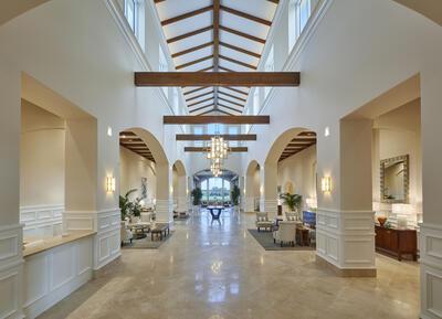 391 Isle Ct, Palm Beach Gardens, FL 33418 - lobby featuring a high ceiling, a decorative wall, and a wainscoted wall