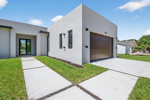 3920 Espan Ct, Palm Springs, FL 33461 - modern home with concrete driveway, stucco siding, a front yard, and an attached garage