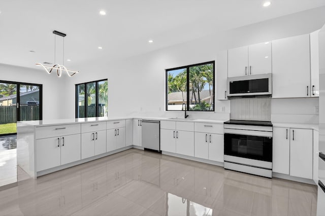 3920 Espan Ct, Palm Springs, FL 33461 - kitchen featuring white microwave, electric stove, stainless steel dishwasher, recessed lighting, and light countertops