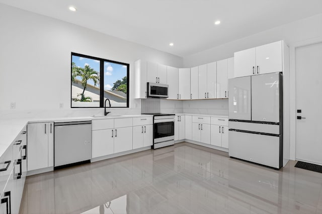 3920 Espan Ct, Palm Springs, FL 33461 - kitchen with stainless steel appliances, recessed lighting, white cabinetry, and light tile patterned flooring