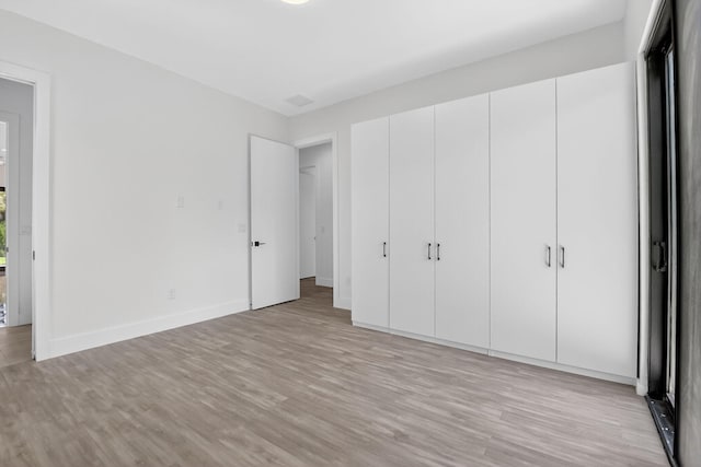 3920 Espan Ct, Palm Springs, FL 33461 - unfurnished bedroom with light wood-style flooring and a closet