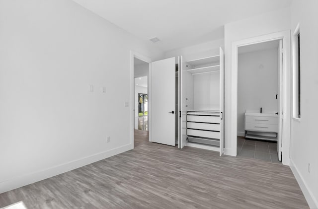 3920 Espan Ct, Palm Springs, FL 33461 - unfurnished bedroom with wood finished floors and ensuite bath