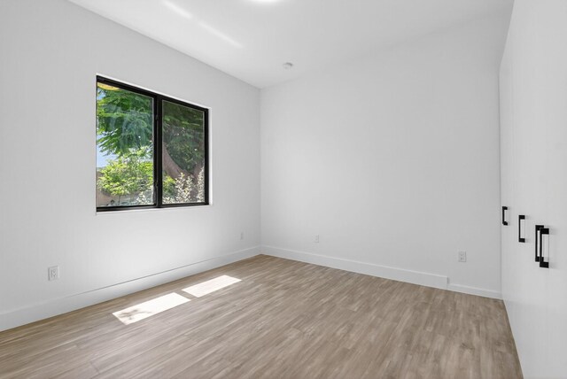 3920 Espan Ct, Palm Springs, FL 33461 - spare room featuring light wood finished floors and baseboards
