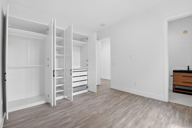 3920 Espan Ct, Palm Springs, FL 33461 - unfurnished bedroom featuring wood finished floors and a closet