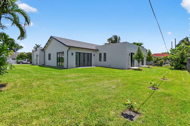 3920 Espan Ct, Palm Springs, FL 33461 - rear view of house with stucco siding and a lawn