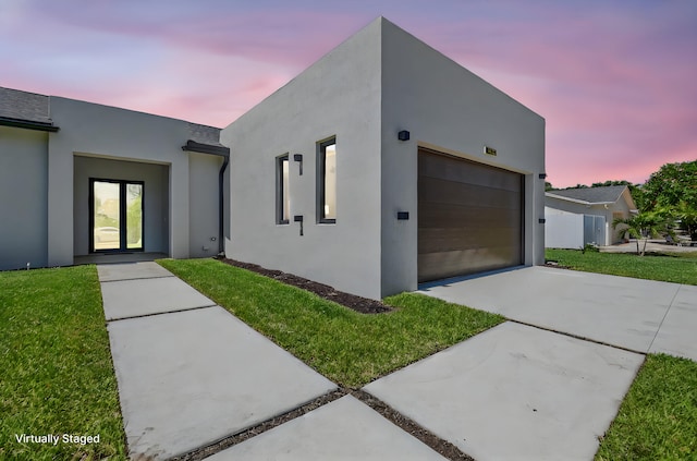 3920 Espan Ct, Palm Springs, FL 33461 - modern home with driveway, stucco siding, a front yard, and an attached garage