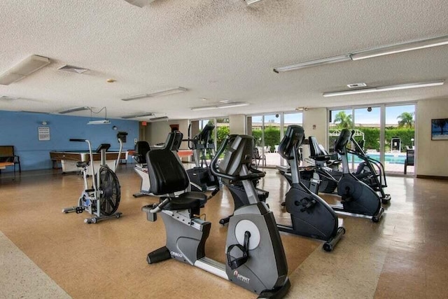 705 Lori Dr Unit 104, Palm Springs, FL 33461 - exercise room featuring a textured ceiling