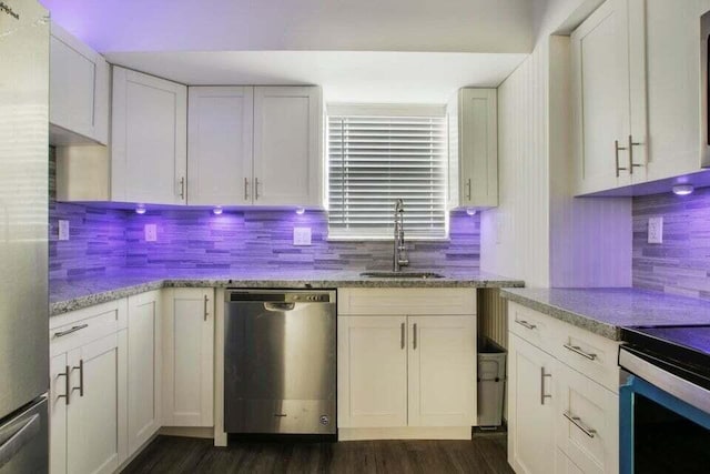 705 Lori Dr Unit 104, Palm Springs, FL 33461 - kitchen featuring stainless steel appliances, a sink, dark wood-style flooring, tasteful backsplash, and light stone counters