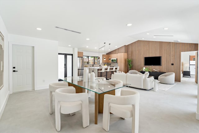 3701 NW 8th St, Delray Beach, FL 33445 - dining area with vaulted ceiling, wooden walls, an accent wall, recessed lighting, and baseboards