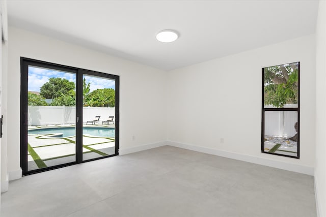 3701 NW 8th St, Delray Beach, FL 33445 - empty room featuring finished concrete floors and baseboards
