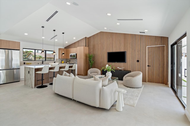 3701 NW 8th St, Delray Beach, FL 33445 - living area featuring vaulted ceiling, wooden walls, plenty of natural light, and recessed lighting