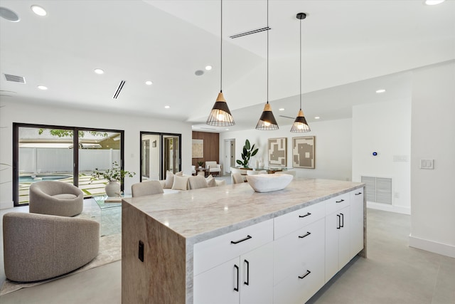 3701 NW 8th St, Delray Beach, FL 33445 - kitchen featuring open floor plan, concrete floors, recessed lighting, light stone countertops, and a center island