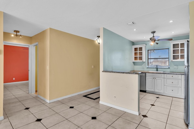 2765 Ashley Dr W Unit C, West Palm Beach, FL 33415 - kitchen with ceiling fan, white cabinetry, appliances with stainless steel finishes, glass insert cabinets, and light tile patterned flooring