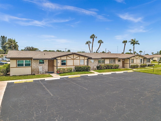 2765 Ashley Dr W Unit C, West Palm Beach, FL 33415 - view of front facade with uncovered parking, stucco siding, and stone siding
