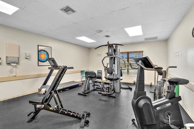 2765 Ashley Dr W Unit C, West Palm Beach, FL 33415 - workout area featuring a paneled ceiling and baseboards