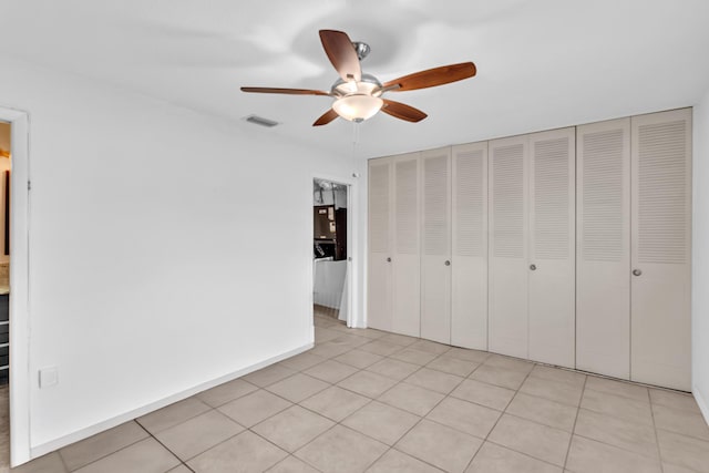 2765 Ashley Dr W Unit C, West Palm Beach, FL 33415 - unfurnished bedroom with light tile patterned floors, a closet, and ceiling fan