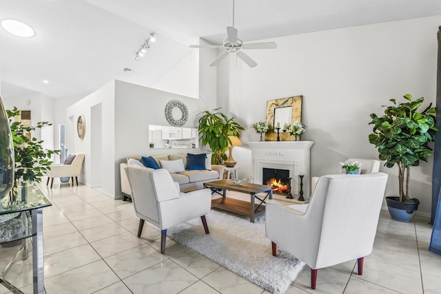 6392 Long Key Ln, Boynton Beach, FL 33472 - living area featuring a lit fireplace, ceiling fan, track lighting, and high vaulted ceiling