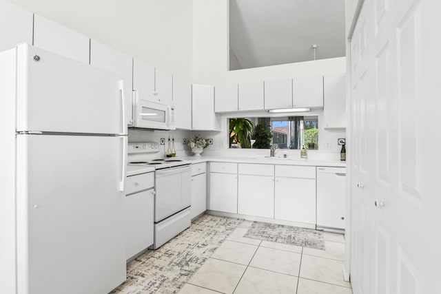 6392 Long Key Ln, Boynton Beach, FL 33472 - kitchen featuring white appliances, light countertops, white cabinets, and high vaulted ceiling