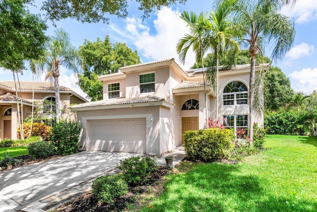 3995 Majestic Palm Way, Delray Beach, FL 33445 - mediterranean / spanish-style house with stucco siding, a front lawn, driveway, an attached garage, and a tiled roof