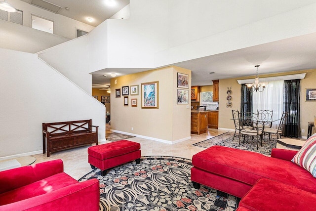 3995 Majestic Palm Way, Delray Beach, FL 33445 - living room with a chandelier, light tile patterned floors, and a towering ceiling