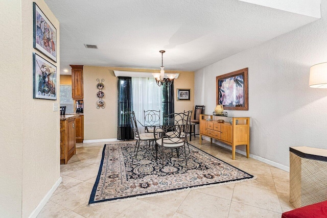 3995 Majestic Palm Way, Delray Beach, FL 33445 - dining area featuring a chandelier, a textured wall, light tile patterned floors, and a textured ceiling