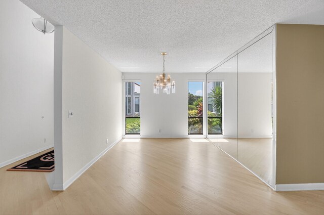 19630 Sawgrass Cir Unit 2901, Boca Raton, FL 33434 - living room featuring light wood-style floors, a chandelier, and a high ceiling