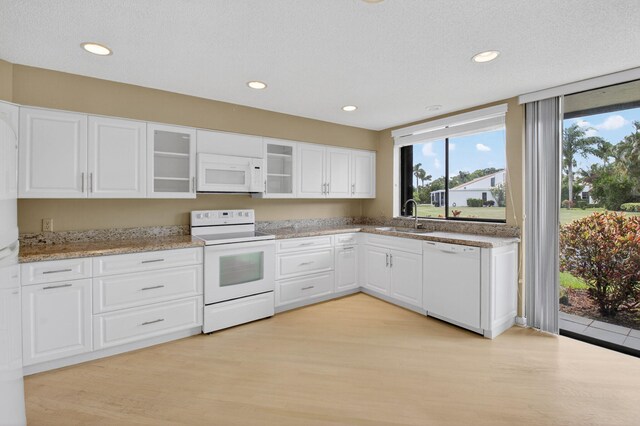 19630 Sawgrass Cir Unit 2901, Boca Raton, FL 33434 - kitchen with white appliances, light wood finished floors, white cabinets, glass insert cabinets, and a textured ceiling