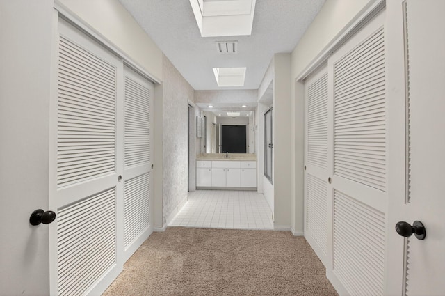 19630 Sawgrass Cir Unit 2901, Boca Raton, FL 33434 - hall featuring light carpet and a skylight