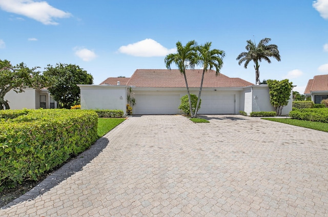 19630 Sawgrass Cir Unit 2901, Boca Raton, FL 33434 - view of front of home featuring a tiled roof, an attached garage, decorative driveway, and stucco siding