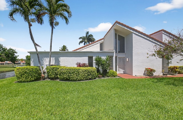 19630 Sawgrass Cir Unit 2901, Boca Raton, FL 33434 - view of property exterior with stucco siding, a yard, a tile roof, and a water view