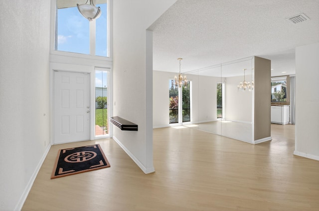 19630 Sawgrass Cir Unit 2901, Boca Raton, FL 33434 - entryway with a chandelier, wood finished floors, and a textured ceiling