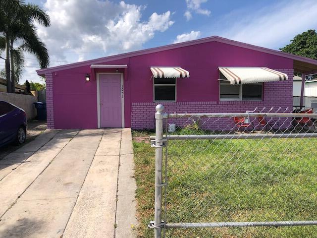 1052 W 26th St, Riviera Beach, FL 33410 - view of front of house with brick siding
