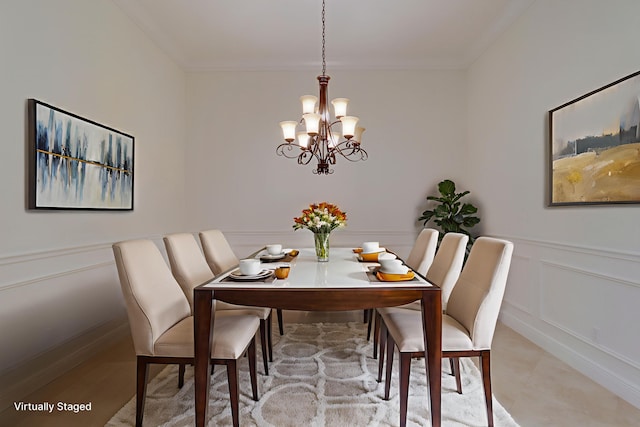 10479 SW Visconti Way, Port Saint Lucie, FL 34986 - dining area featuring a chandelier, crown molding, a decorative wall, and a wainscoted wall
