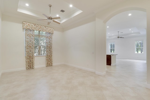 10479 SW Visconti Way, Port Saint Lucie, FL 34986 - empty room with a raised ceiling, ceiling fan, arched walkways, recessed lighting, and light tile patterned floors
