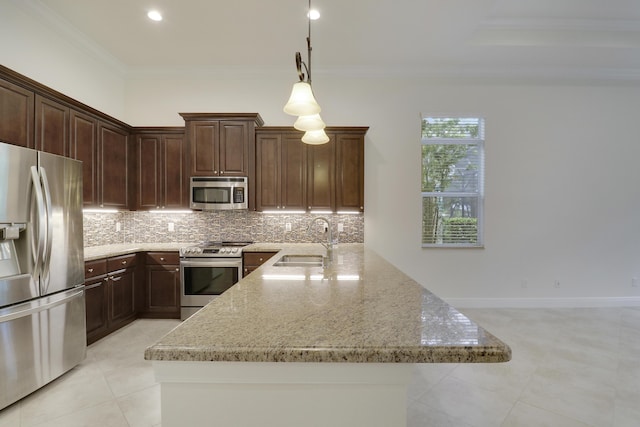 10479 SW Visconti Way, Port Saint Lucie, FL 34986 - kitchen with stainless steel appliances, crown molding, tasteful backsplash, light stone counters, and light tile patterned flooring