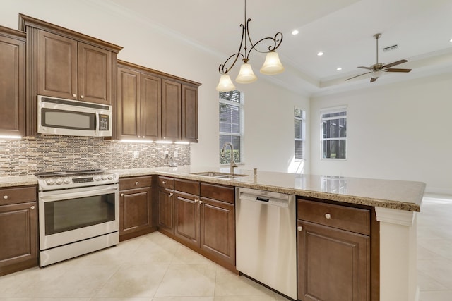 10479 SW Visconti Way, Port Saint Lucie, FL 34986 - kitchen with appliances with stainless steel finishes, a peninsula, a ceiling fan, tasteful backsplash, and light tile patterned flooring