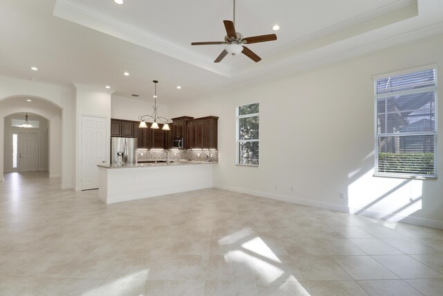 10479 SW Visconti Way, Port Saint Lucie, FL 34986 - unfurnished living room with ornamental molding, arched walkways, a raised ceiling, recessed lighting, and ceiling fan